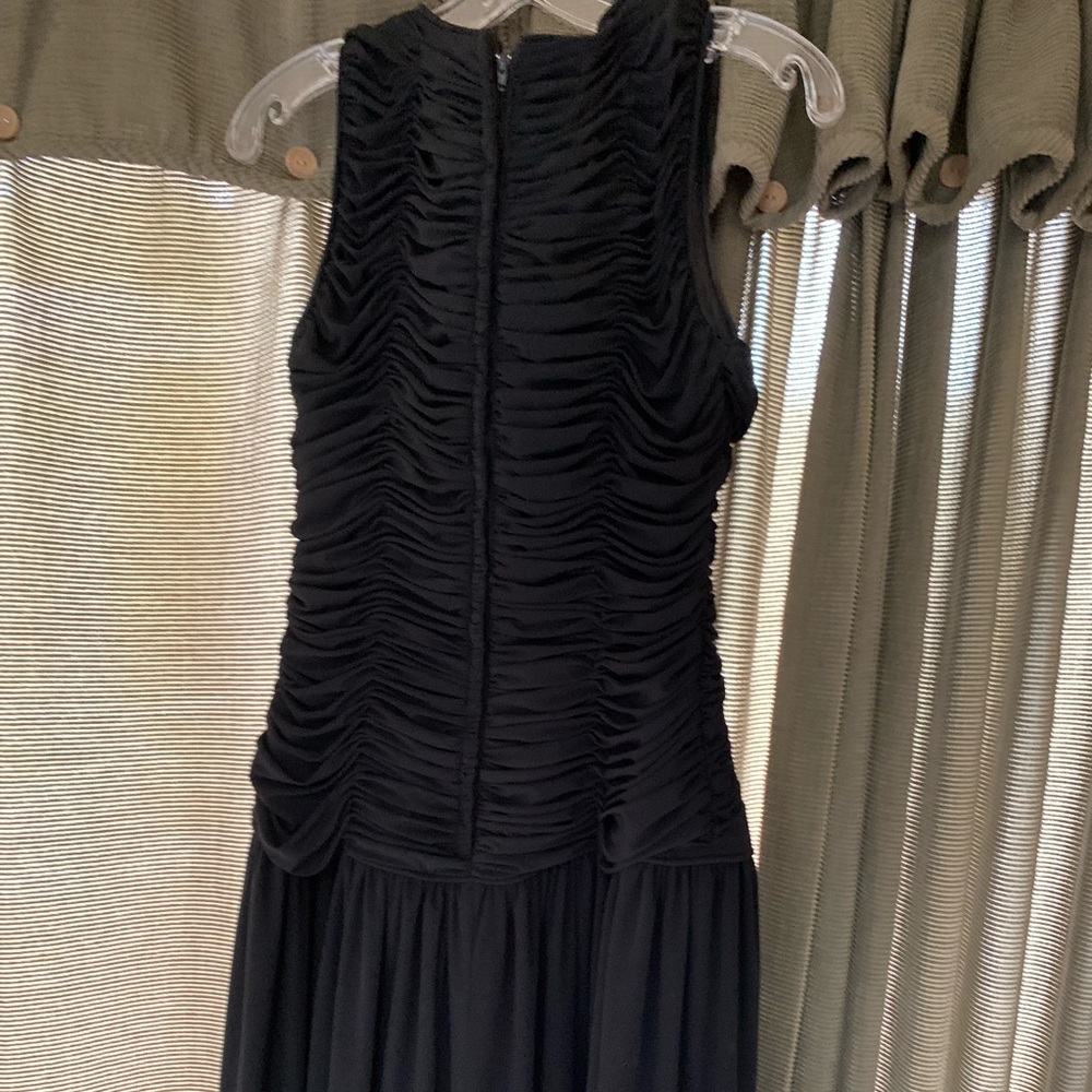 Full length gown with slit in skirt. Sheered at top. Sleeveless. Black